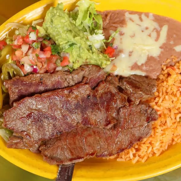 Patron Mexican Grill's carne asada with rice, refried beans, guacamole, and pico de gallo.