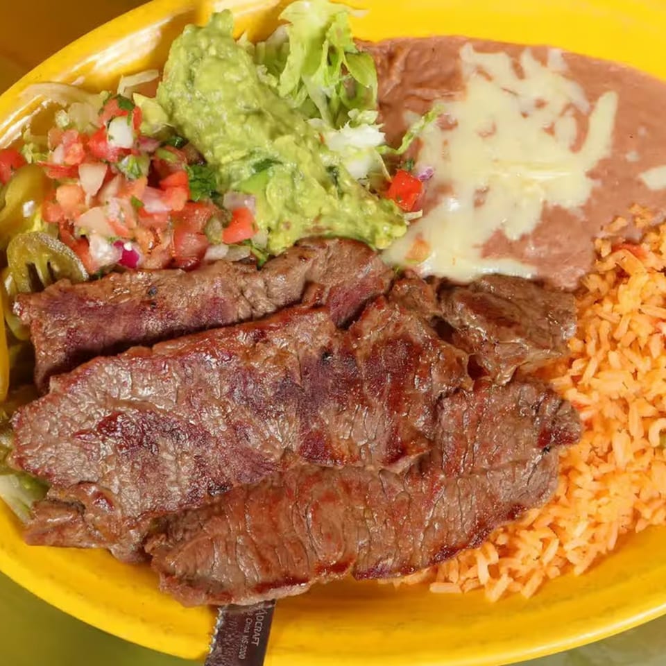 Patron Mexican Grill's carne asada with rice, refried beans, guacamole, and pico de gallo.