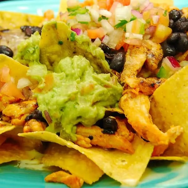 Close-up of Patron Mexican Grill's nachos with chicken, guacamole, black beans, and pico de gallo.