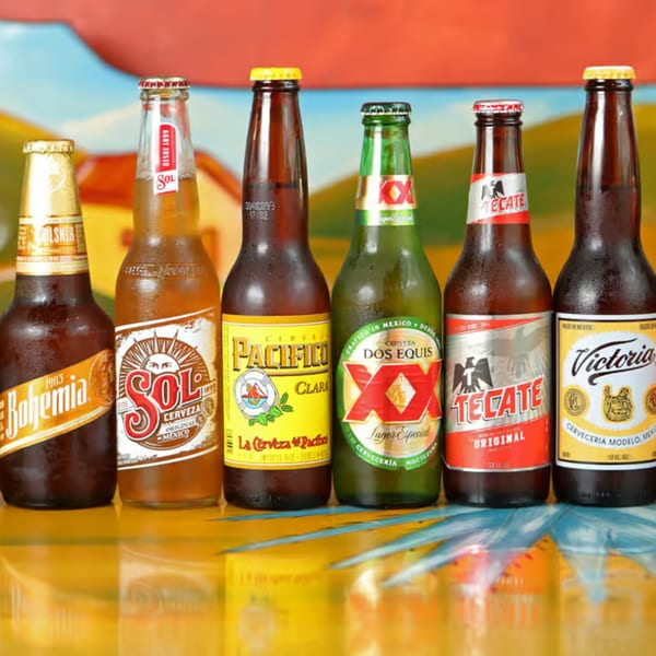 Six bottles of popular Mexican beers, including Sol, Pacifico, Dos Equis, Tecate, and Victoria.